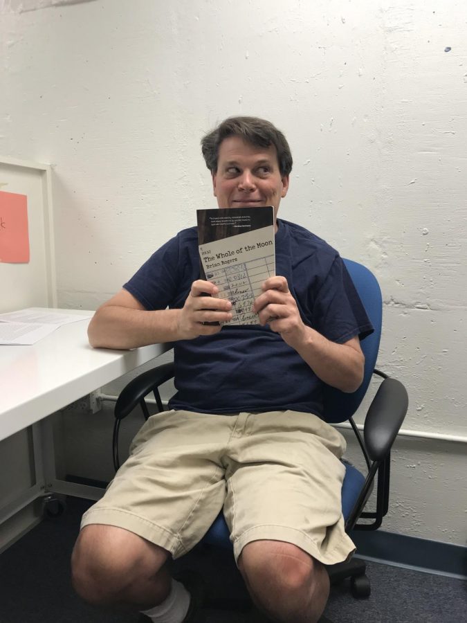 Mr. Rogers holds up a copy of his book!
