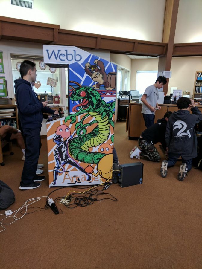 Webbies work on the video game cabinet in Fawcett Library.