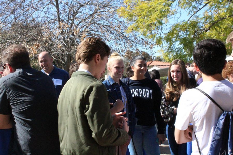 Lily Miller (‘21), Cheyaan Jamal (‘21), and Ashley Cox (‘21) conver se and engage with visiting students in the Quad. 
