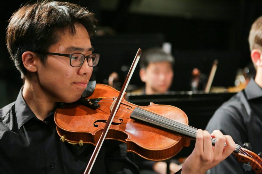 Jun Kim (19) follows the music and bows out the melodies. Graphic Courtesy of Scott Nichols