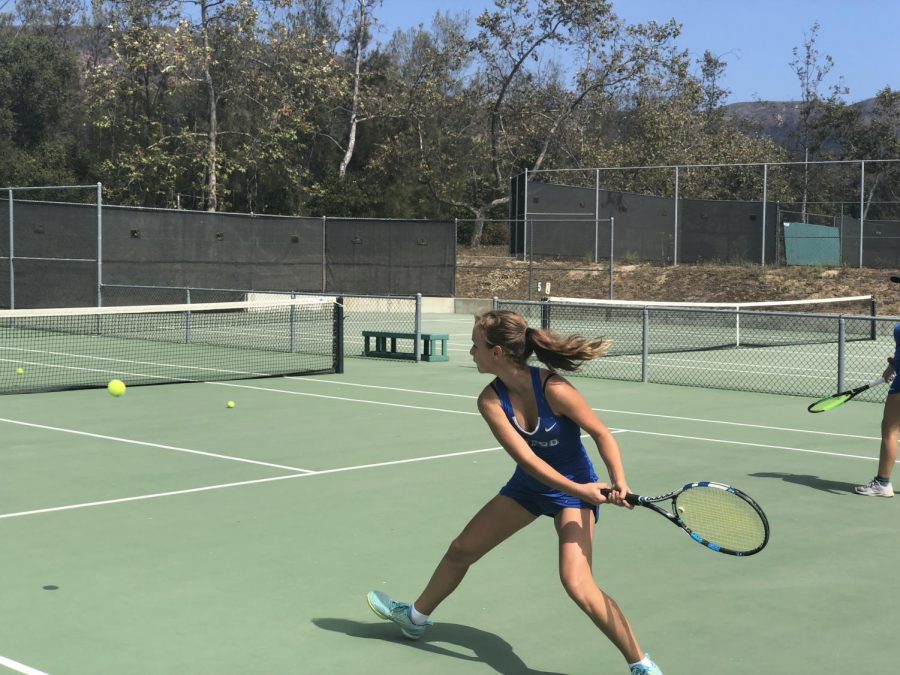 Mariia Lykhtar (22) hits a backhand cross court during warm-up.