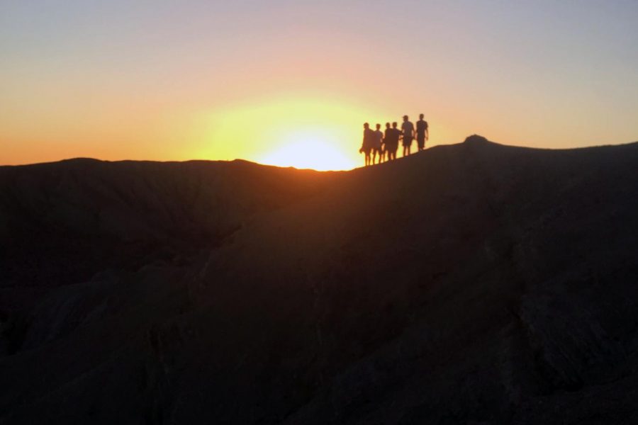 Freshmen boys stand over the desert hills in Barstow during sunset. Photo courtesy of Arshia Sazi (‘22).