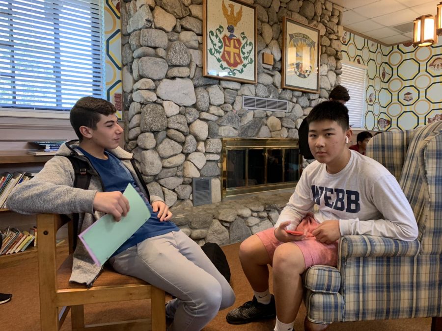 Richard Alrachid (22) and Brian Yeung (22) talk while wearing AirPods.