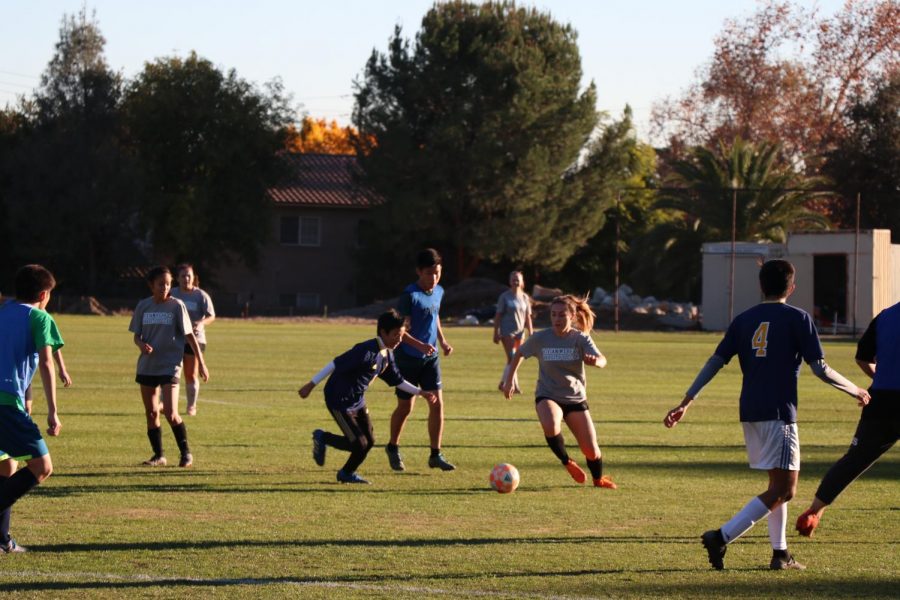 Emily Stepanian (19) dribbles the ball while Jordan Granda (22) defends on Chandler Field. 