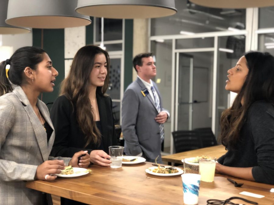 Malika Neogi (20) and Lydia Toy (20) strike up a conversation with a VWS alum attendee.