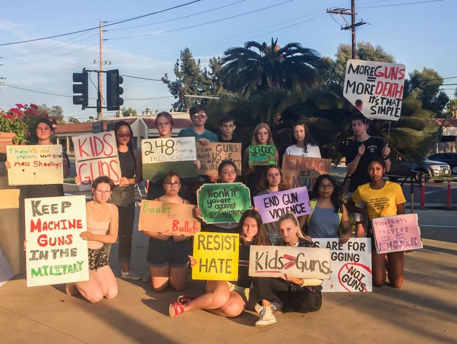 Lily+Miller+%28%E2%80%9821%29+and+a+group+of+15+other+high+school+students+pose+on+the+corner+of+Indian+Hill+and+Foothill+Blvd.+holding+their+colorful+signs+against+gun+violence.