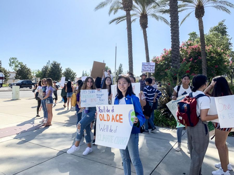 Shuci Zhang (‘23) holds a sign that advocates for climate reform.