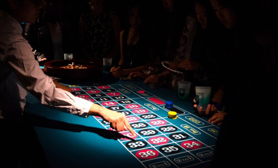 A roulette dealer sets up the table for the night.
