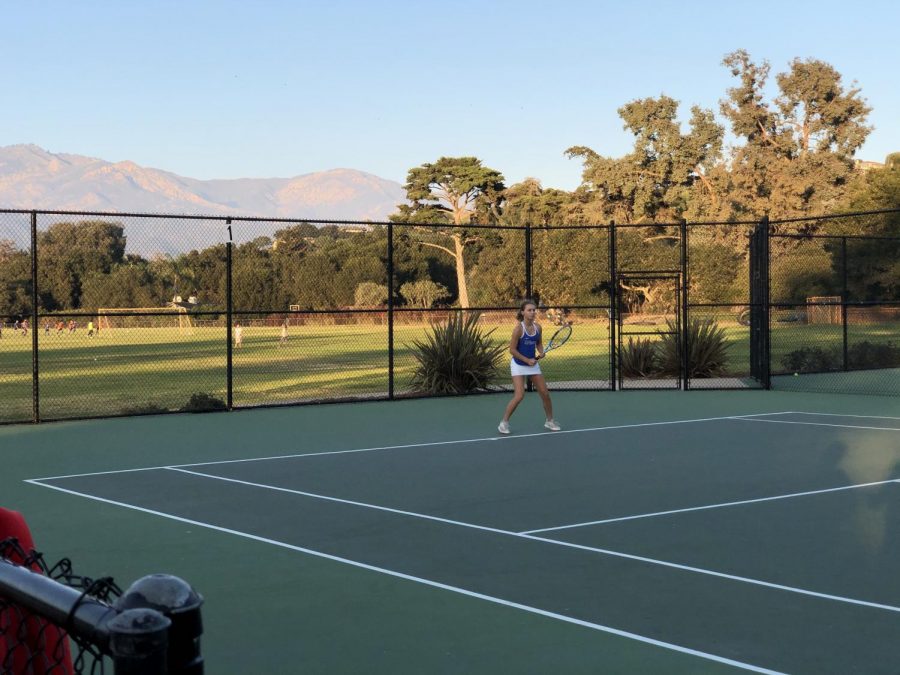 Mariia Lyktar (22) prepares to hit a forehand down-the-line shot from the baseline.