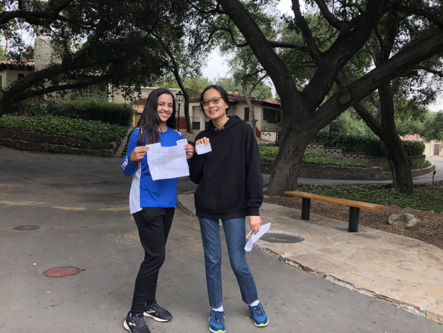 Katie Arzate (‘23) and Yvette Shu (‘23) smile at Crossroads with commodities that they are hoping to use to earn more money in the game. 