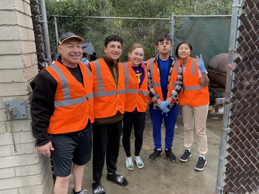 Jim Dahler, math department faculty, Hunter Lange (‘22), Nichola Monroe (‘22), Fran Torrez (’22), and Joanna Yap (’22) smile after depositing the trash bags behind the Price Dining Hall.