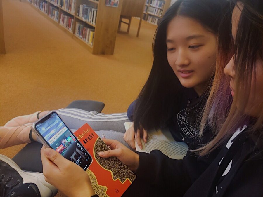 Cynthia Pan (‘23) and Jessica Cao (‘23) watch a TikTok about the war with Iran. 