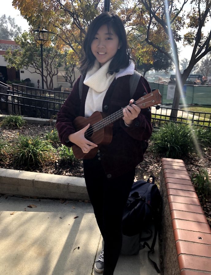 Joanna Yap (‘22) poses with her guitar.
