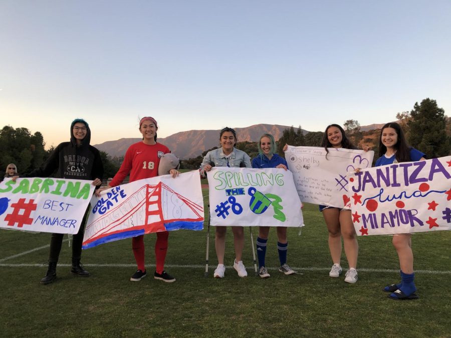 Seniors on the team, including manager Sabrina Chavez (‘20), Bridgette Lee (‘20), Tina Kabbouche (‘20), Molly Mitchell (‘20), Shelby Mocrkicky (‘20), and Janitza Luna (‘20), pose with senior game posters after the game. Graphic courtesy of Janitza Luna.