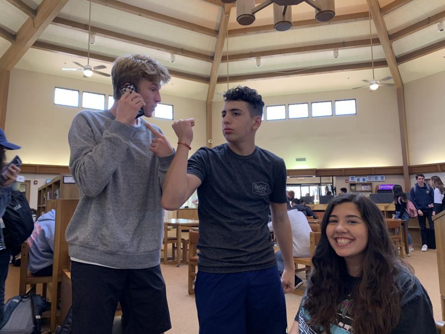 Claire Diepenbrock (‘21), Max Fargo (‘21), and Johnathon Maschler (‘21) listen and dance to music in the library.