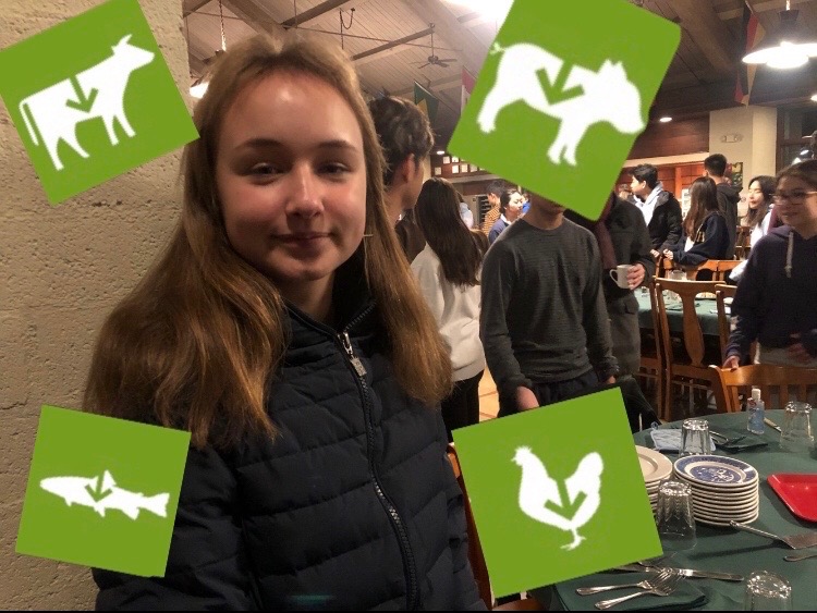 Mariia Lykhtar (‘22), a pescatarian, considers the importance of reducing meat consumption at community dinner.