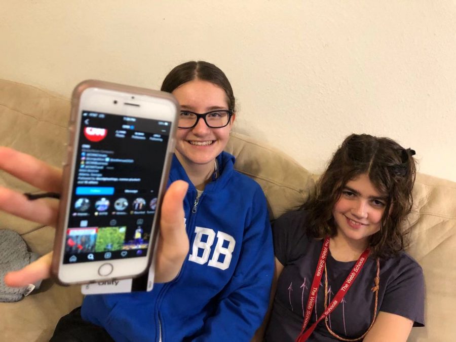 Molly Ratinoff (‘23) and McKenna Boyle (‘23) hold the phone that shows CNN’s Instagram page.
