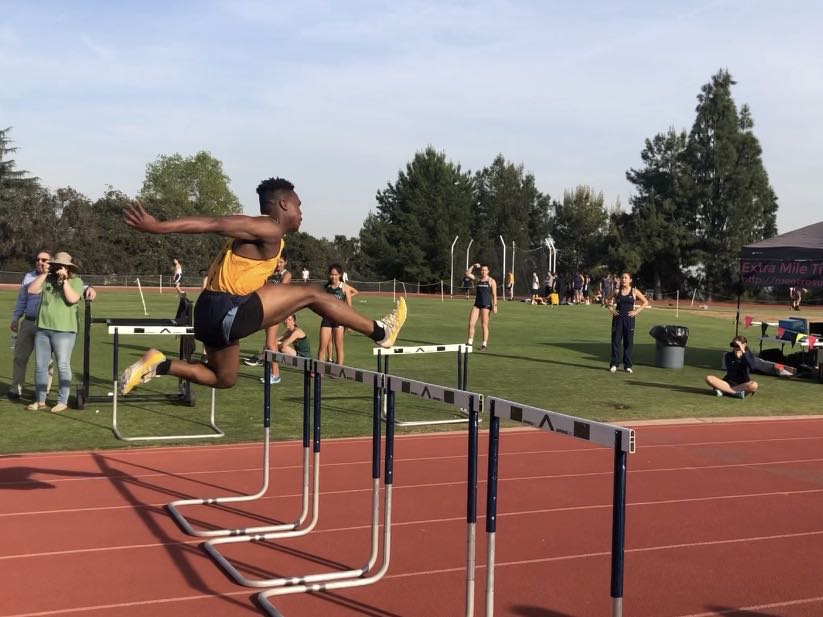 Christopher Haliburton (‘20) jumps over the last hurdle to finish the race.