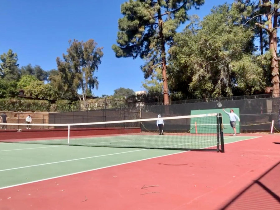 Jaydyn Akpengbe (‘22) and Matthew Gooch (‘22) practice tennis before afternoon activities.
