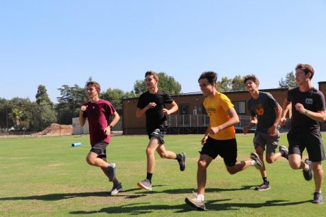 Garret Cordova Caddes (‘23), Etienne Griffon (‘23), Aidan Helgeson (‘23), Matt Maschler (‘24), and Nick Theobald (‘22) run together in a warm-up to prepare for practice. 
