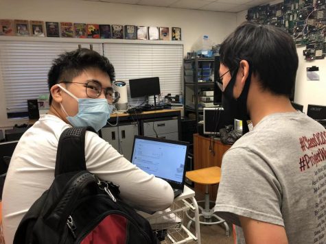 Gerry Song (‘22) and Nathan Choi (‘22) learn to make new folders in the tech office.