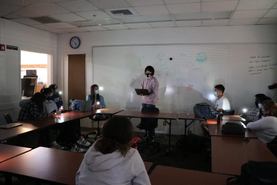 Ada Liu (‘24) recites an original poem at the Bookworm Club’s poetry reading event during Wednesday long lunch. The other club members raise their phones, flashlights turned on, to create a solemn but encouraging ambience as they absorb the words of her poem.  