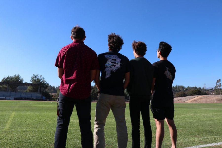 From left to right: Bradyn Wishek (‘22), Jimmie McCloud (‘22), David Hastings (‘22) and Hank Sun (‘22) look back on faculty field as they leave it for the last time as football players.