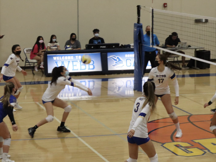 Sophia Bachoura (‘22) passes the ball during a game to Savanna Cespedes (‘22) as Nicole Rabadi (‘24) gets ready for the kill.