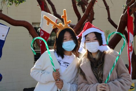 Day student prefects Angie Zhang (‘23) and Kaylynn Chang (‘23) dress up in festive clothing to collect donations for local charities for the holidays. The upcoming holidays spark conversations between the girls about their plans for the break. After her DSP duties, Angie returns to her homework during her free block to finish her art project. “I’m so excited for break and the workload isn’t too bad, but I just want it to be break already,” Angie said.  