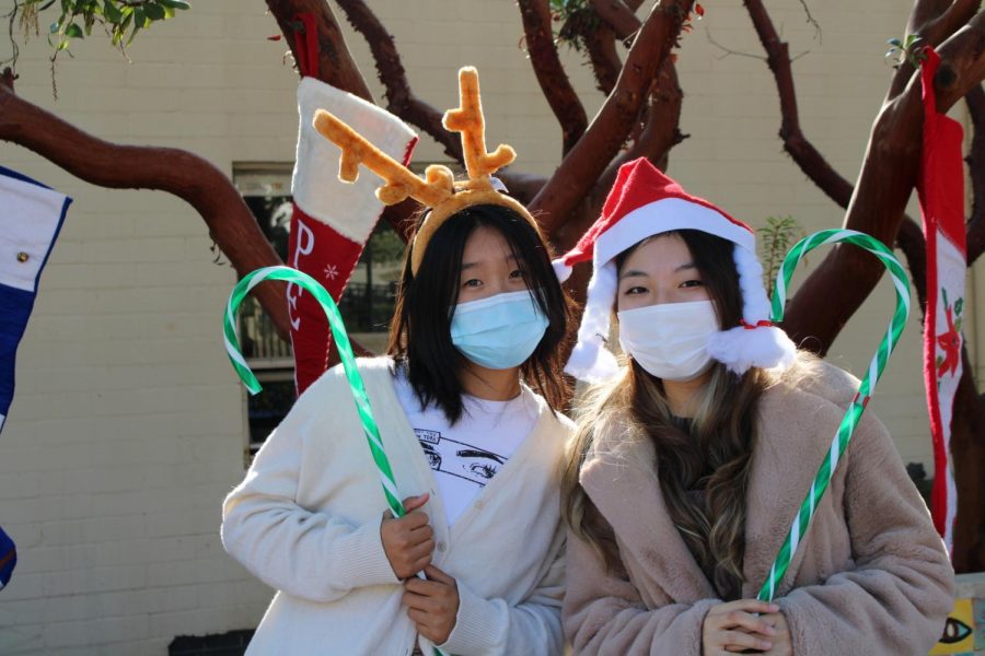 Day+student+prefects+Angie+Zhang+%28%E2%80%9823%29+and+Kaylynn+Chang+%28%E2%80%9823%29+dress+up+in+festive+clothing+to+collect+donations+for+local+charities+for+the+holidays.+The+upcoming+holidays+spark+conversations+between+the+girls+about+their+plans+for+the+break.+After+her+DSP+duties%2C+Angie+returns+to+her+homework+during+her+free+block+to+finish+her+art+project.+%E2%80%9CI%E2%80%99m+so+excited+for+break+and+the+workload+isn%E2%80%99t+too+bad%2C+but+I+just+want+it+to+be+break+already%2C%E2%80%9D+Angie+said.++