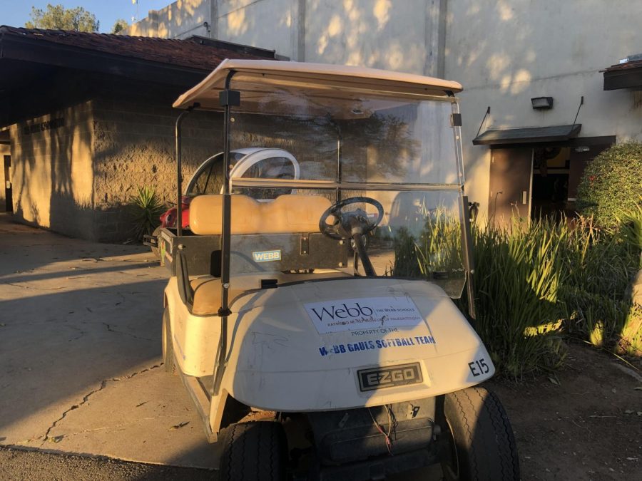 The VWS varsity softball golf cart sits in front of the gym, unused. The golf cart has space in the back to store gear such as softball nets, buckets of balls, and bags. This is because carrying all this gear up and down hills can be strenuous. 