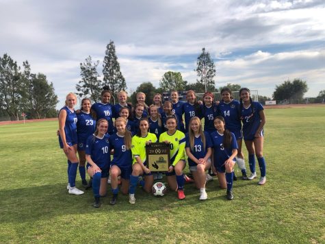The team poses together, with the two goalies holding their award. After an undefeated season, winning the CIF championship award was the perfect way to end before they head onto State championships. 