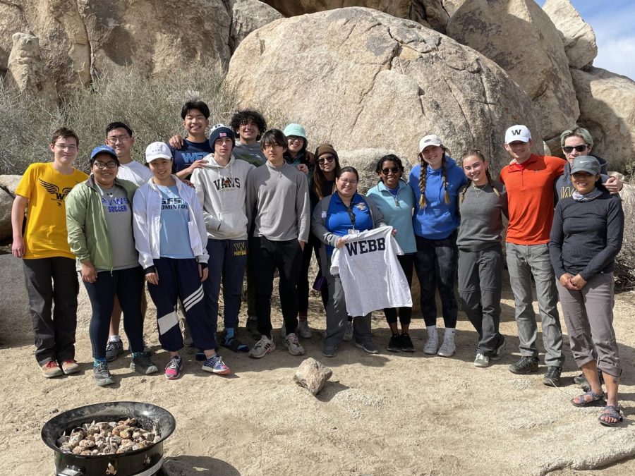 Webb+students+on+the+Climbing+Through+History+course+take+a+photo+with+a+representative+of+the+29-palm+band+of+tribal+Indians+in+Joshua+Tree+National+Park.+She+talked+about+the+history+of+the+tribes+in+the+park%2C+and+the+areas+that+they+consider+sacred+today.+%0ACredit%3A+Howie+Kalter