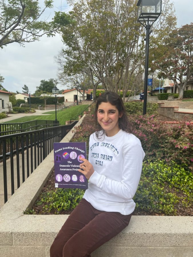 Isabella Saeedy (‘23) with her book “The Domestic Violence Awareness Project”