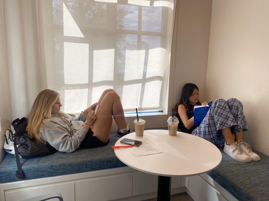  Kaitlyn Metz (‘25) and Christina Young (‘25) are studying in the Hooper Community Center during their free block, unmasked. “I am happy that we are able to unmask indoors now; it is nice to see what everyone’s faces really look like,” Kaitlyn said.  
