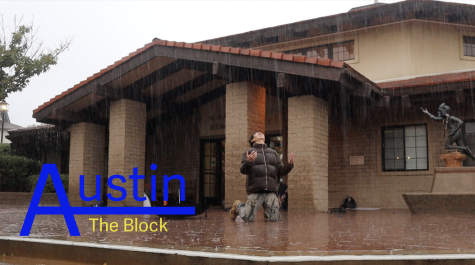 Austin Ra (23) kneels as intense rain falls down on him. Austin poses in front of Fawcett Library on a rainy day for his new episode of Austin on the Block. 