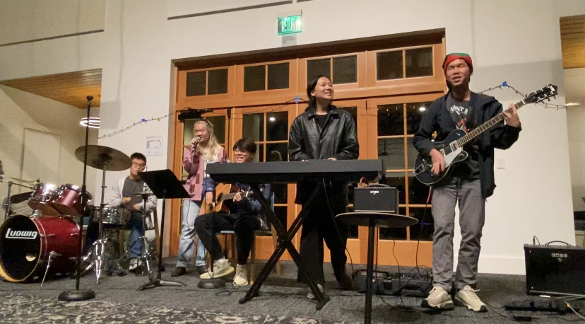 With Stanley Jian (23) on the electric guitar, Yvette Shu (23) on the keyboard, and Conrad Poon (23) on the drums, they are performing a cover of Night Changes by One Direction at the Holiday Party in Hooper. As Eunice Lau (23) and Richard Wu (23) sing the lyrics, Richard is also strumming along on his acoustic guitar. Together, the five seniors make up the Tonics.