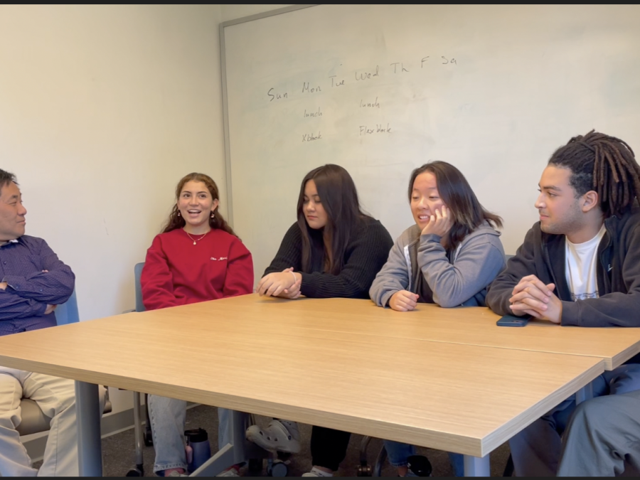 John Choi, Director of Equity, Valeria Gonzalez (‘23), Gabby Diaz (‘23), Izzy Kim (‘24), Ale Fountain (‘24), and Kenny Clay (‘25) gather around a table and reflect and compare their experiences at the 2021 and 2022 Student Diversity Leadership Conferences.