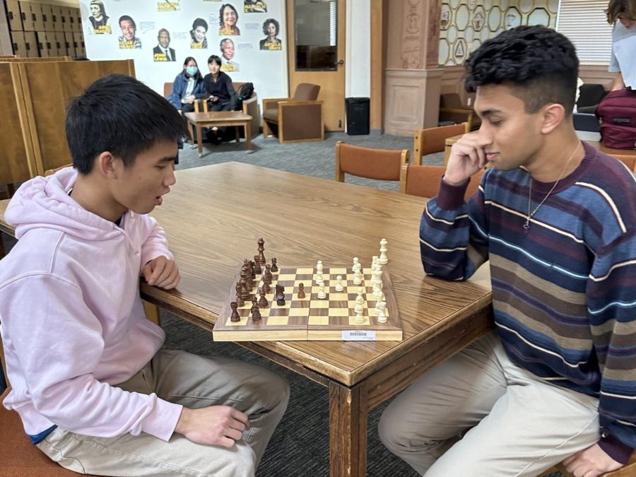 Viraj Nigam (23) and Ben Thien-Ngern (23) are engaged in a competitive game of chess, where they are utilizing both their strategic thinking and analytical abilities in order to emerge victorious. 