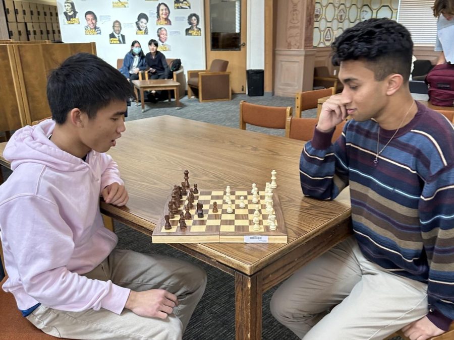 Viraj Nigam ('23) and Ben Thien-Ngern ('23) are engaged in a competitive game of chess, where they are utilizing both their strategic thinking and analytical abilities in order to emerge victorious. 