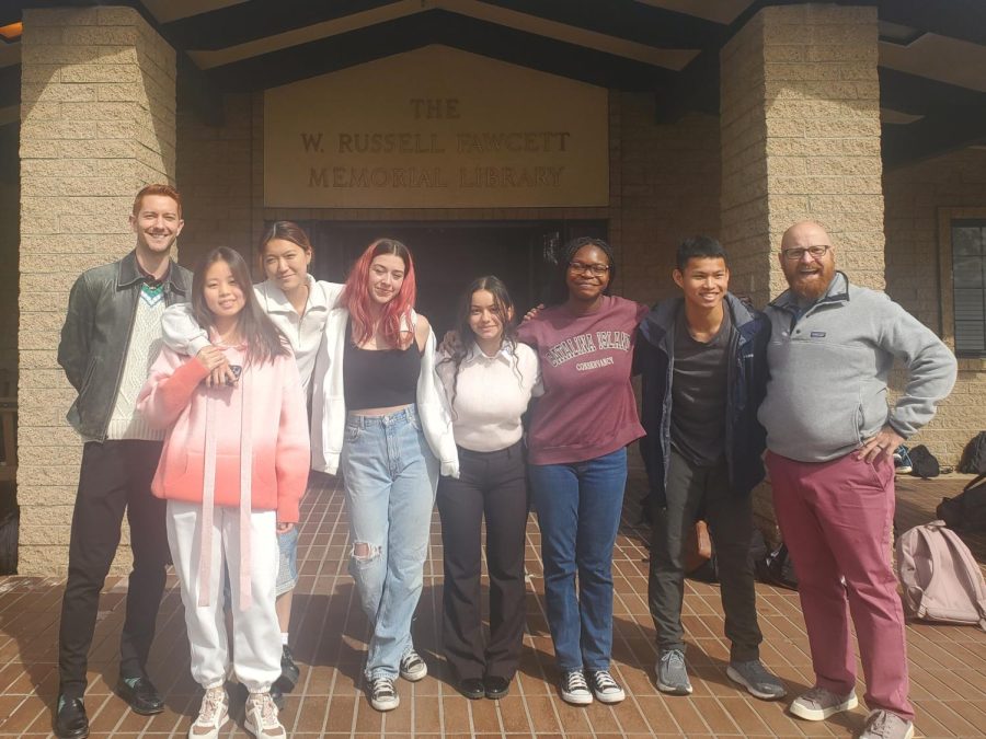 Webb students embarking on the Spring Break trip to Bolivia pose in front of Fawcett Library. From left to right are Michael Szanyi, Humanities Department faculty, Jamie Zeng (‘23), Wendy Chang (‘23), Marina Saeger (‘23), Jackie Shugert (‘24), Wura Ogunnaike (‘23), Ken Lin (24), and Stephen Hebert, Humanities Department faculty. This photo captures most, but not the entire travel group, all excited for the trip.   