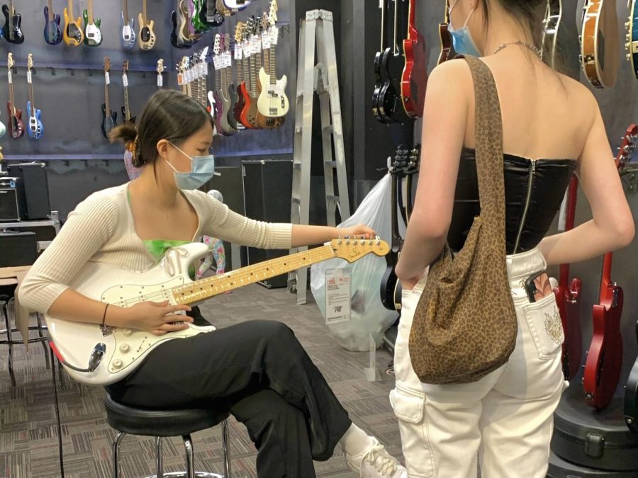 Karen Chen (‘23) plays a guitar as her sister observes. Music has always been a part of Karen’s life, and she continues to develop her skills in her free time. 