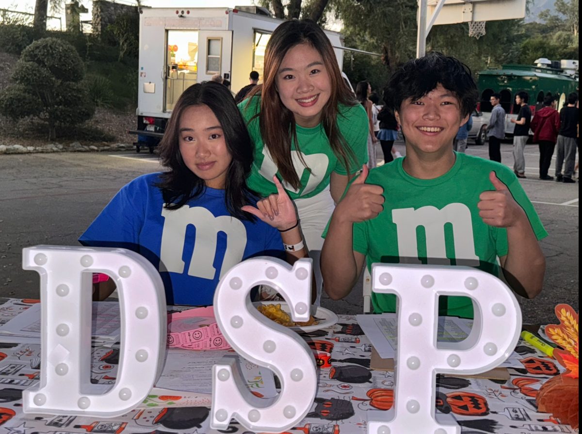 The DSPs Kevin Wang (‘24), Hannah Hao (‘24), and Kate Alvarez (25) smile at the camera as they prepare for the DSP Fall Social. Students can come to the front table and line up to get tickets for pie and free boba. From 5:30 p.m. to 9:00 p.m., students were coming up the gym hill to grab the free desserts. The boba truck, though, was the biggest hit of the night.