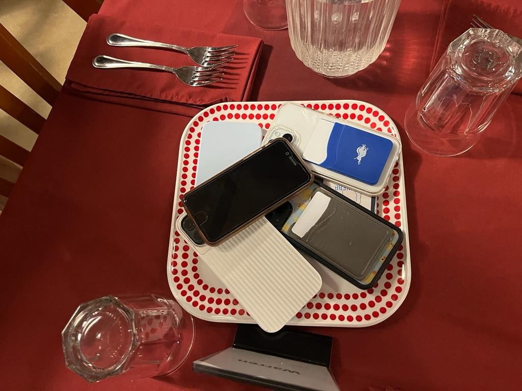 Students place phones on the “phone plate” during community dinner. Although the policy is newly introduced, similar rules related to responsible technology use have already been in place during chapel and community dinners. “Nobodys going to disagree that everyone being on their phones is a problem in human society right now,” said Michael Hoe, Assistant Head of Schools.
