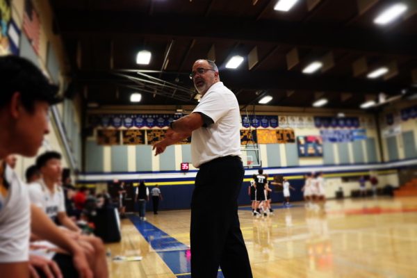 WSC varsity basketball head coach Micheal Dunford coaches his team on the sideline, directing each player exactly what he wants to see out on the court. He sends in substitutes to have a fresh lineup on the court, replacing all the starters.  
