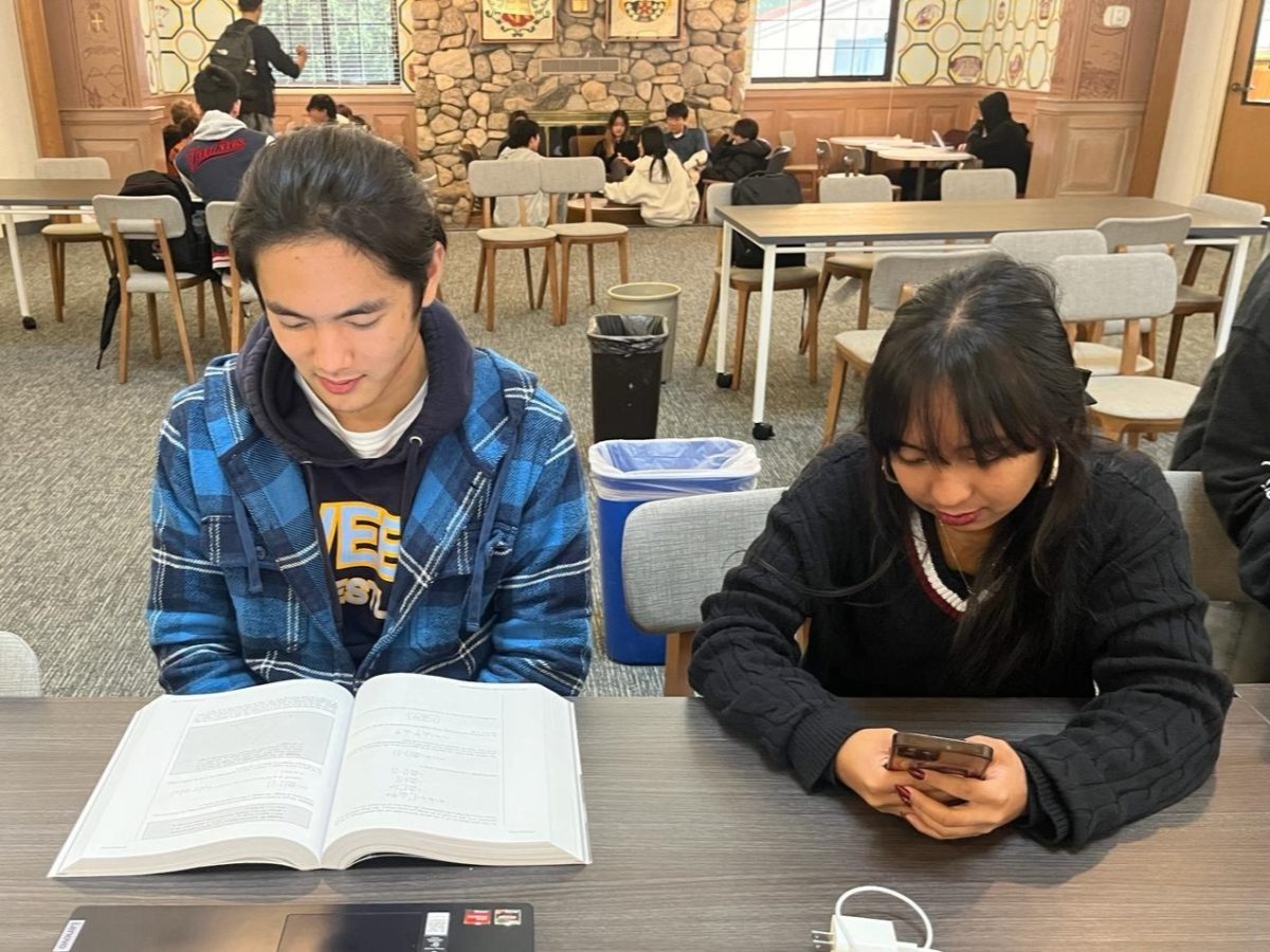 Hanbo Xu (‘25) and Leia Albornoz (‘25) sit side by side during a long lunch in the Fawcett library. On the left side, Hanbo is diligently working on his physics homework, and on the right side, Leia is procrastinating on schoolwork by scrolling through Instagram reels. Social media and technology are one of the easiest ways to procrastinate. “I concentrate and stop procrastinating by setting a 15-minute timer on Instagram and putting my phone outside my room,” Hanbo Xu (‘25) said. 