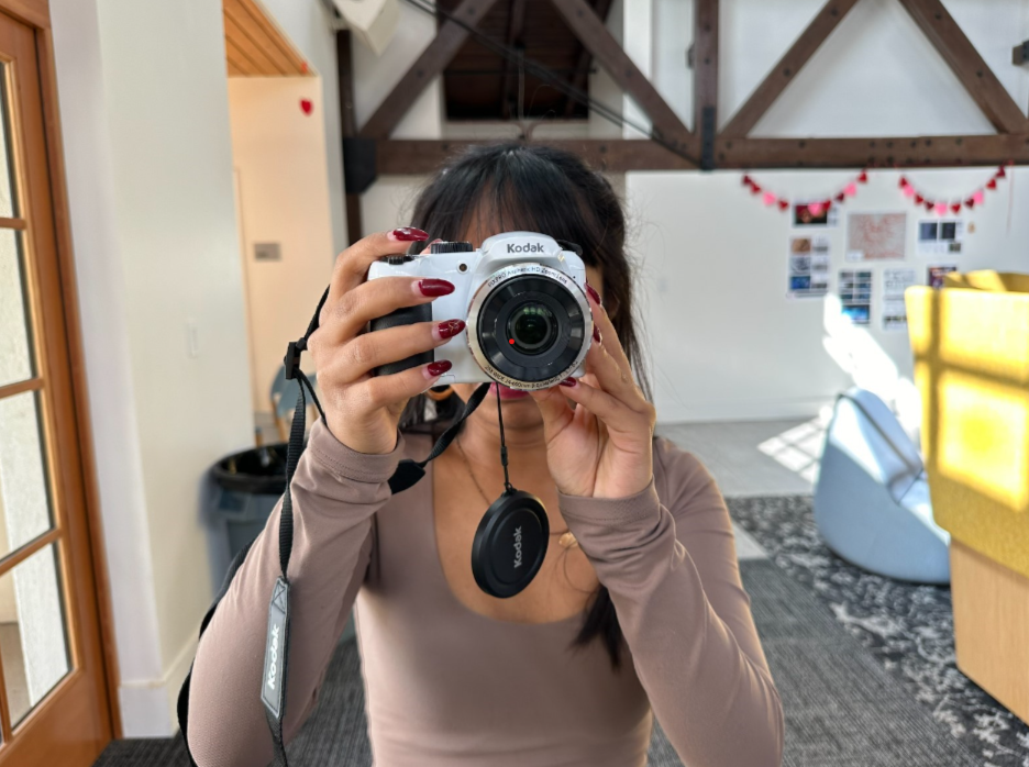 Getting ready to catch an unforgettable moment, Leia Albornoz (‘25) has her Kodak digital camera ready at hand.  After toggling through many settings, she holds it up to her to ensure a precise and sharp flick! 