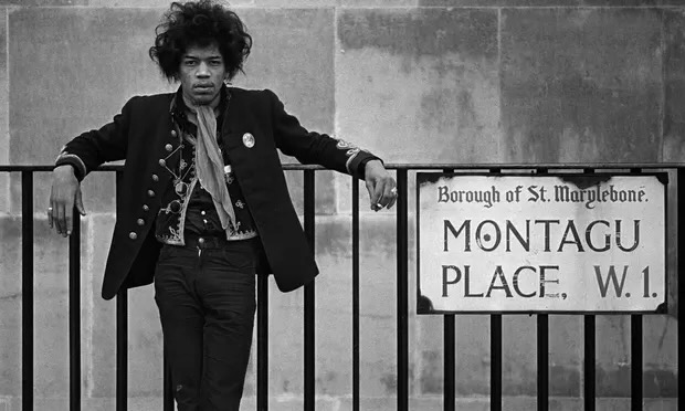 Jimi Hendrix standing in front of Montagu Place W1, famous hotel in London.