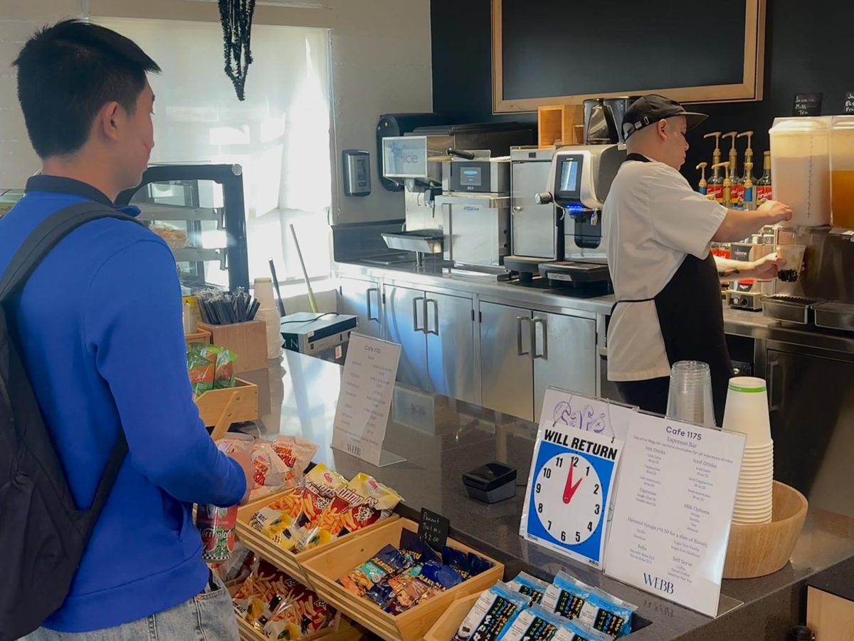 Frequent Cafe 1175 visitor Daniel Xue (’27) purchases a jasmine milk tea and a choco bun after patiently waiting in a long line during X Block. The cafe offers savory and sweet breads, ordered from 85º Bakery every morning, along with a choice of coffees, teas, and refreshments. “One of my favorite items to purchase is the Arizona [tea],” said Daniel. Cafe 1175 offers a variety selections that students enjoy and is looking forward to new additions of foods in the future. 