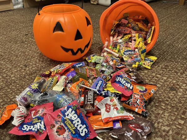 A large variety of candies is spilling out of a pumpkin trick-or-treat bucket. As Halloween comes to an end, students count their candies and pick out the ones they like to save while arguing over which one is ultimately the best. “Halloween is one of my favorite holidays because I love candies and watching movies,” said Tychelle Moore Cul-pepper (’27). Students have had a fruitful Halloween this year and continue to look forward to next year’s celebration.